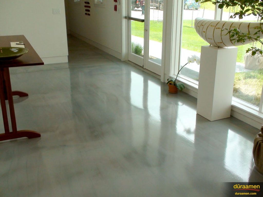 The sunlight reflects off the metallic epoxy flooring in the fine art gallery.