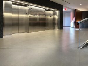 Self-leveling concrete topping with polyurethane topcoat. FISERV Financial Technology Services, WI, USA. elevator lobby