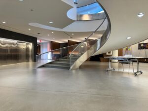 Self-leveling concrete topping with polyurethane topcoat. FISERV Financial Technology Services, WI, USA. Staircase and lobby
