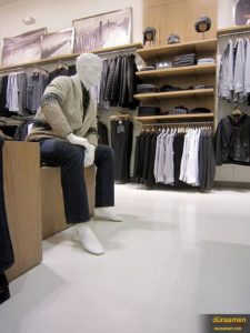 A maniquin admires the high-end concrete flooring solution at the Perri Ellis Outlet store.