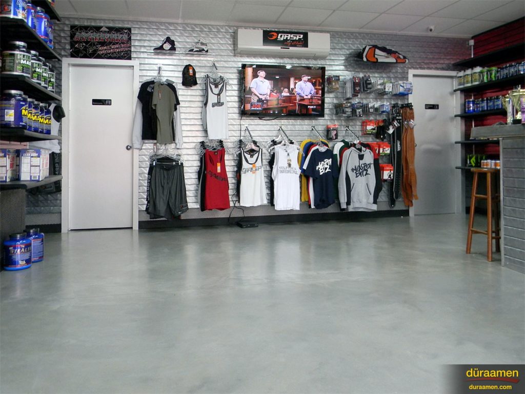 The merchandise of this fitness retailer stands out thanks to the clean, smooth contemporary concrete overlay flooring.