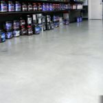 Upon close inspection, subtle monochromatic colors in the concrete flooring can be seen. Concrete dyes were used on a newly installed concrete overlay to achieve this effect.