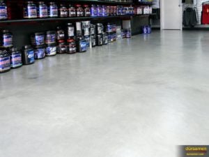Upon close inspection, subtle monochromatic colors in the concrete flooring can be seen. Concrete dyes were used on a newly installed concrete overlay to achieve this effect.