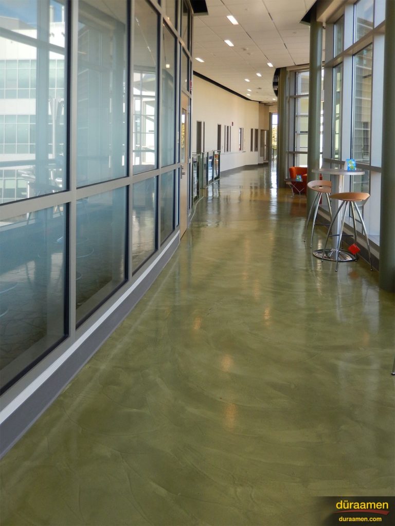 The subtle and beautiful textures and colors of the newly resurfaced concrete flooring compliments the glass panel walls at Southern Connecticut State University (SCSU).