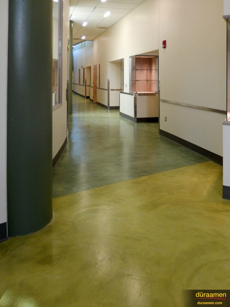 The multi-colored resurfaced concrete floor of this corridor was created with Pentimento by Duraamen.