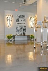 The golds and beige colors of Alex and Ani's high-end resurfaced concrete flooring makes the merchandise look even more stunning.