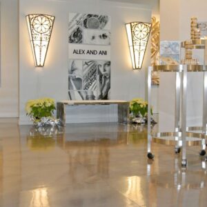 The golds and beige colors of Alex and Ani's high-end resurfaced concrete flooring makes the merchandise look even more stunning.