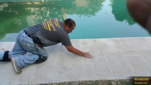 Finishing touches by hand to this walkway around the swimming pool.