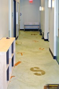 A resurfaced concrete floor yields many design possibilities. This daycare center had letters and numbers stenciled on the floor using playful colors.