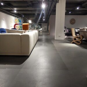 The spot lighting makes the concrete overlay flooring come to life.