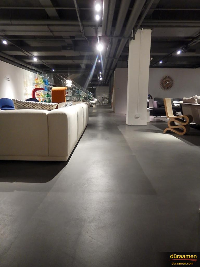 The spot lighting makes the concrete overlay flooring come to life.