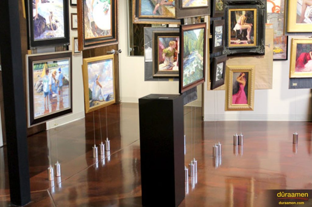 The deep browns of the metallic epoxy floor complement the gallery's interior design.
