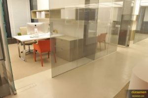 Glass walls and modern concrete flooring.