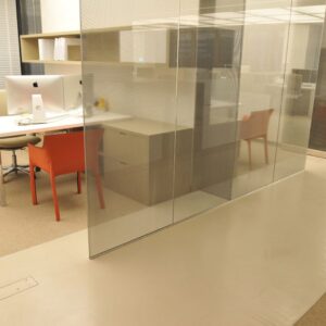 Glass walls and modern concrete flooring.