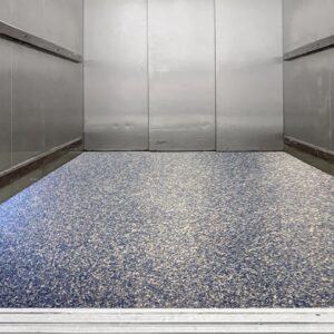 Freight elevator with a polished and seamless epoxy floor coating.