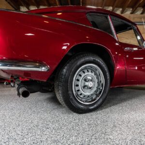 A garage floor coated with epoxy chip floor coating, showcasing a seamless and glossy finish with a captivating blend of colored chips.