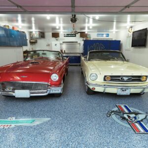 A garage floor with epoxy chip floor coating, showcasing a mix of blue, gray, and white colored chips.