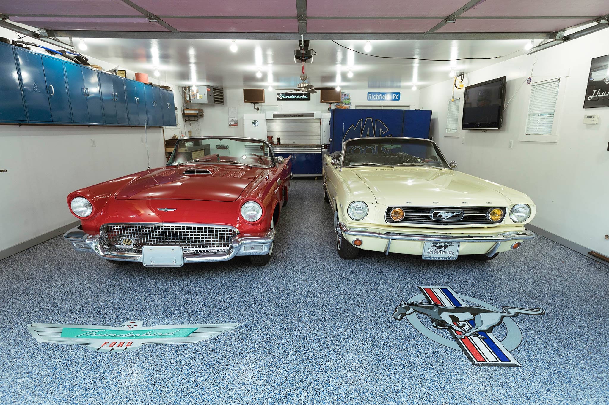Thunderbird and Mustang parked on a garage floor with decorative epoxy chip floor coating The car logos are shown on the floor How to Install a Resin Chip Epoxy Coating Floor System | Duraamen Engineered Products Inc