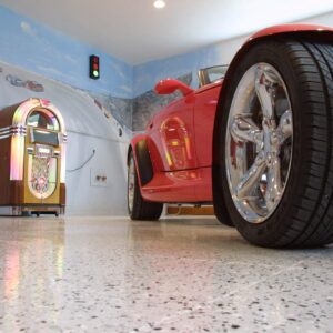 Red hot rod parked in a garage with epoxy chip floor coating and non-slip surface.