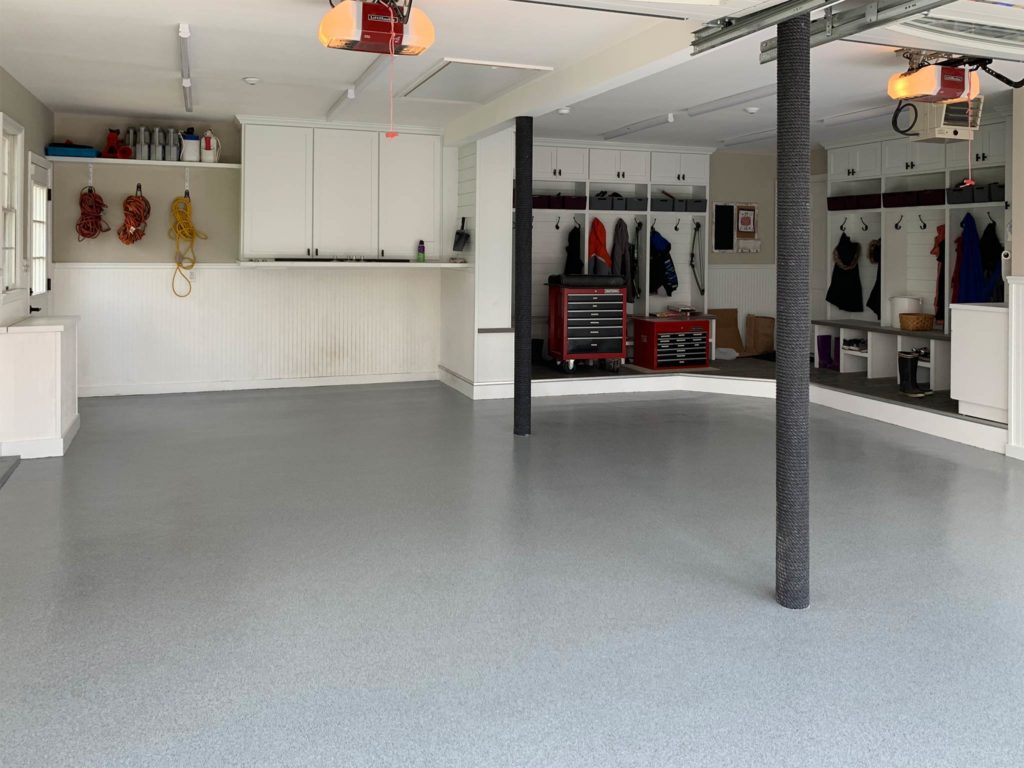 Very nice cool grey and white garage floor with epoxy chip floor coating and non-slip surface.