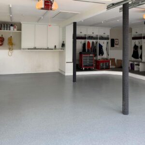Very nice cool grey and white garage floor with epoxy chip floor coating and non-slip surface.