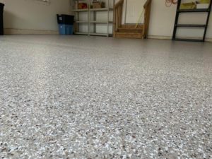 Close-up of a garage floor with epoxy chip floor coating and non-slip surface.