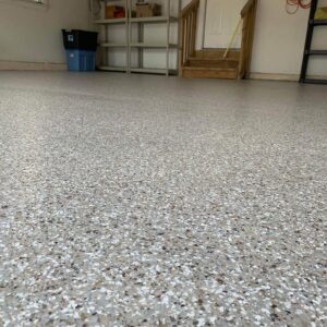 Close-up of a garage floor with epoxy chip floor coating and non-slip surface.