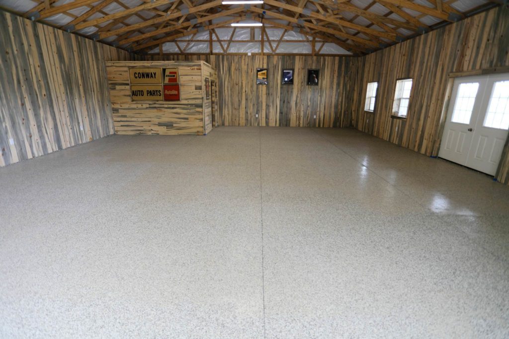 Garage floor with epoxy chip floor coating and non-slip surface in a large barn garage