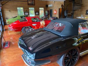 Beautiful metallic epoxy garage floor and 60's corvettes parked