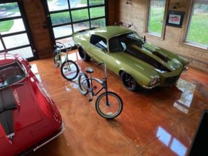 Metallic epoxy garage floor with a green 70 camaro parked