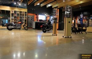 The chrome of a Harley Davidson motorcycle reflects nicely off the polished concrete floor.