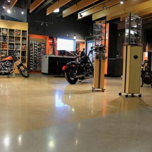 The chrome of a Harley Davidson motorcycle reflects nicely off the polished concrete floor.