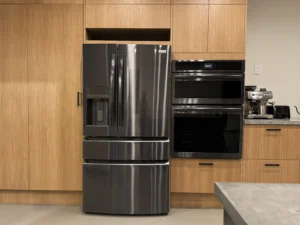 Open kitchen featuring Arapido microcement floors, black appliances, and wood cabinetry.