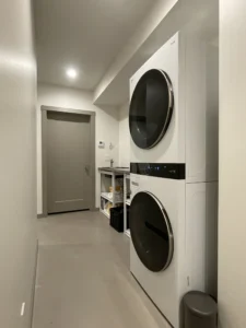 Utility or laundry area with microcement flooring
