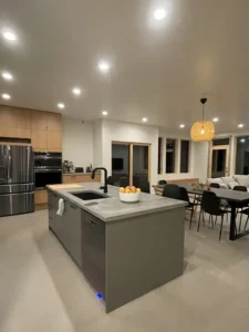 Dining area with pendant light, large windows, and Arapido microcement floor.