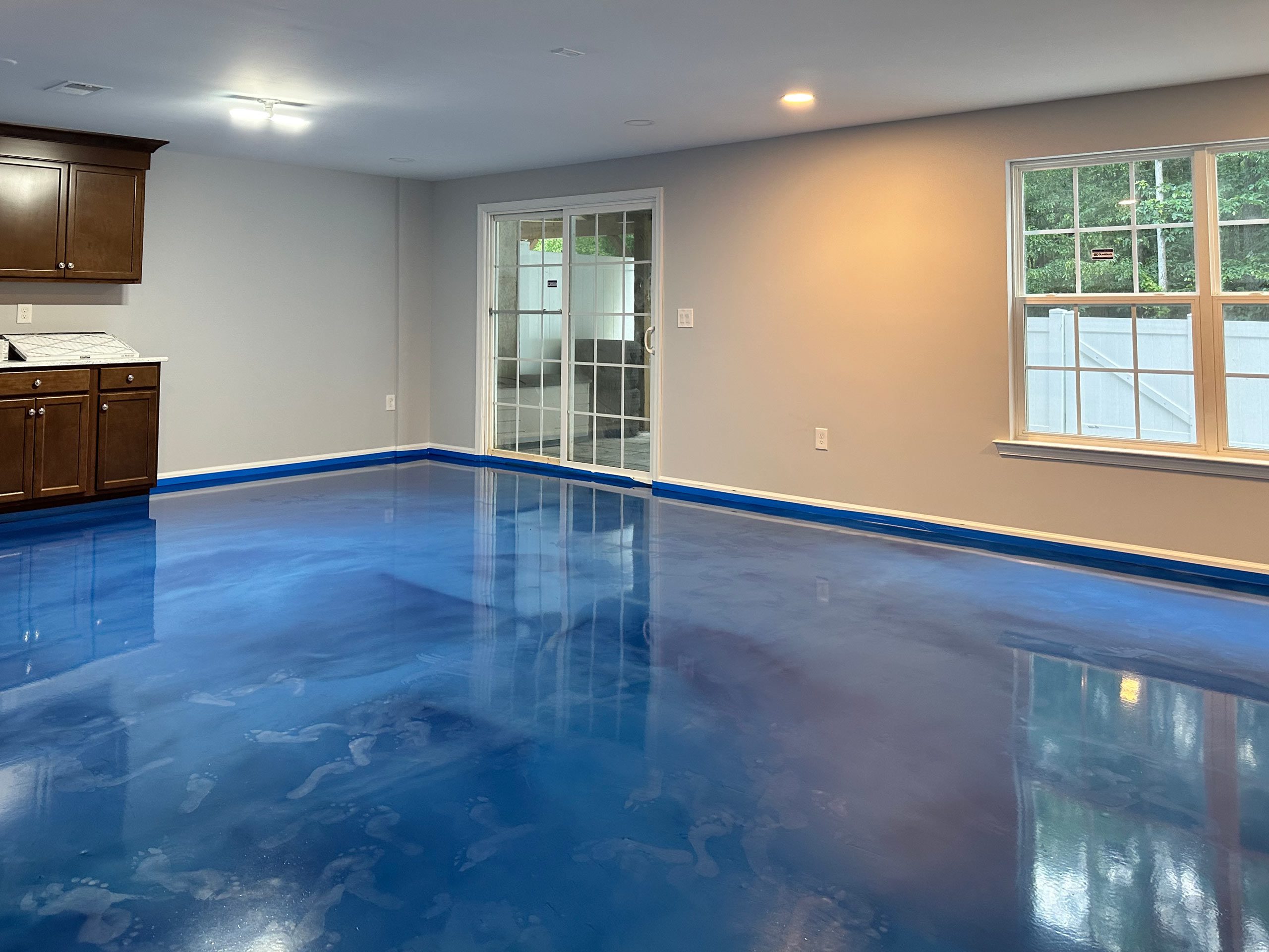 Bright blue metallic epoxy flooring used in a residential basement Monmouth Junction NJ Lumiere by duraamen 2256 Basement in Monmouth Junction NJ | Duraamen Engineered Products Inc
