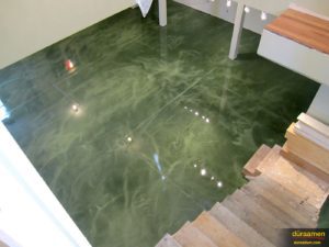 This building entrance has had it's flooring enhanced with a striking green color using metallic epoxy.
