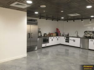 The kitchen has the same beautiful concrete floor as the rest of the shared office space.