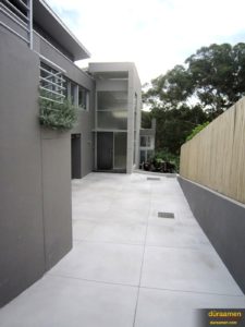 This modern looking Australian home features a concrete overlay driveway.