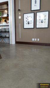 Sealed with water based acrylic and epoxy, the warm grey flooring is the perfect compliment to the existing decor.