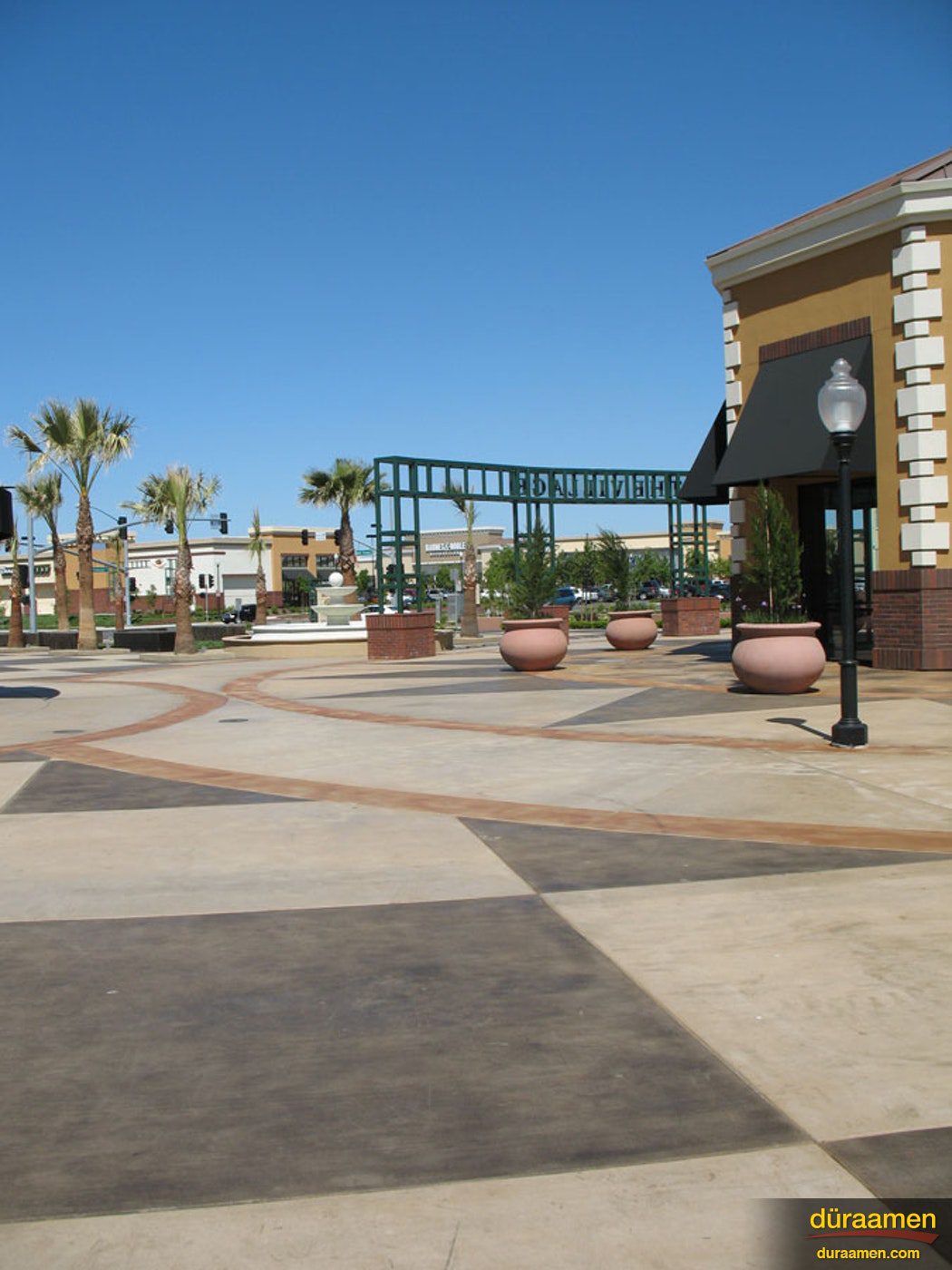 This outdoor lifestyle center features a decorative concrete overlay that was created with Duraamen products Dyes Stains on Walkways in a Retail Center Sacramento CA | Duraamen Engineered Products Inc