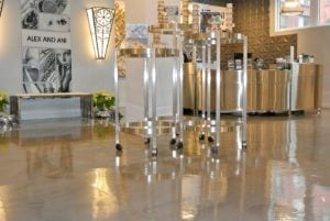 A glossy polished concrete floor with a decorative pattern resembling natural stone in shades of gray and beige.
