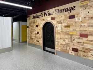 Duraamen's epoxy floor coating and resin chips with a polyaspartic topcoat used as the flooring in this self storage facility. This photo shows the wine storage unit with in the self storage facility.