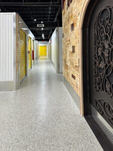 Duraamen's epoxy floor coating and resin chips with a polyaspartic topcoat used as the flooring in this self storage facility. Hallway photo 6.