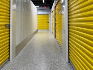 Duraamen's epoxy floor coating and resin chips with a polyaspartic topcoat used as the flooring in this self storage facility. Hallway photo 4.