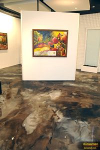 The deep browns, grays and blacks of the floor let the artwork stand out.