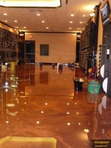 The deep copper colored floor of this wine store was created with metallic epoxy flooring.